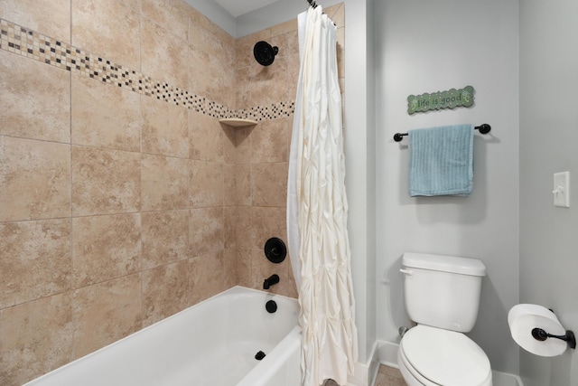 bathroom featuring shower / tub combo and toilet