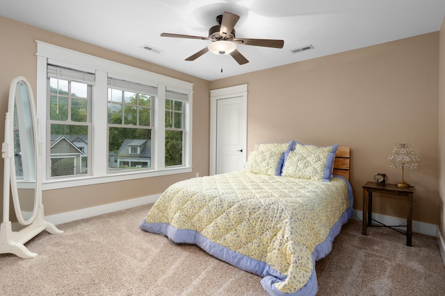 bedroom featuring ceiling fan and carpet