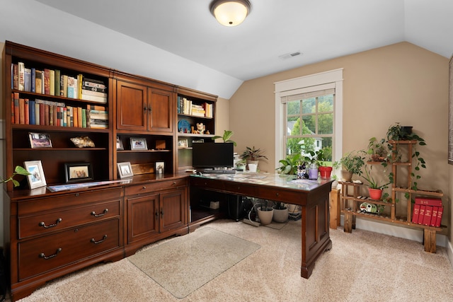 carpeted office with vaulted ceiling