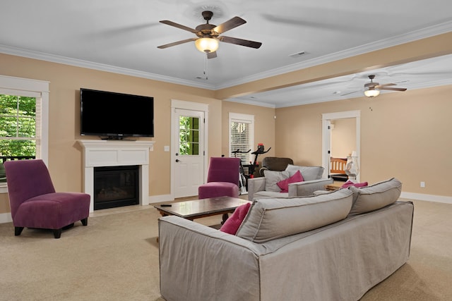 carpeted living room featuring ornamental molding and ceiling fan