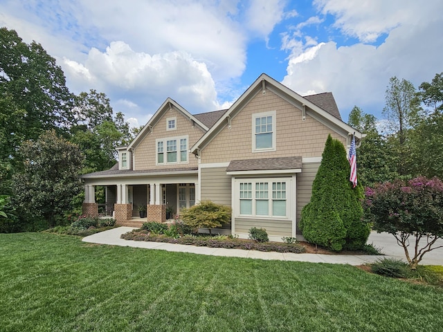 craftsman house with a porch and a front yard