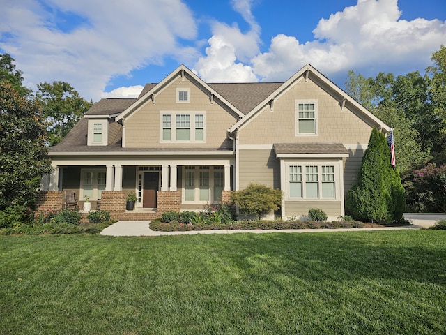 craftsman-style home featuring a porch and a front yard