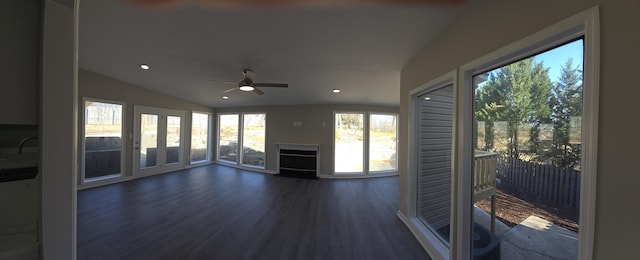 unfurnished living room with lofted ceiling, dark wood-type flooring, and ceiling fan