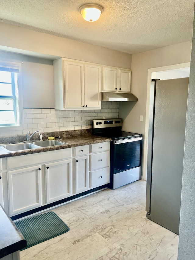 kitchen with stainless steel appliances, white cabinetry, sink, and decorative backsplash