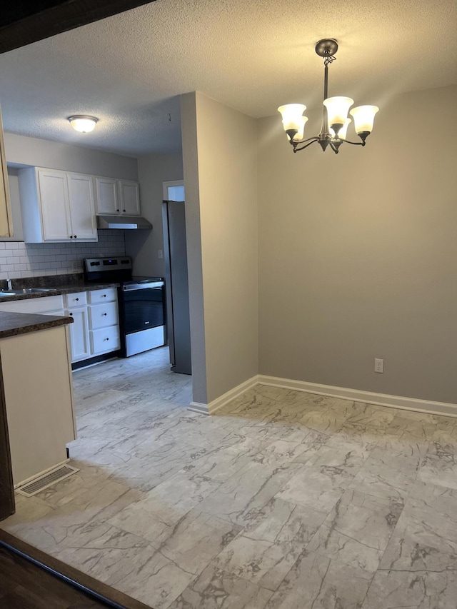 kitchen with stainless steel appliances, decorative backsplash, white cabinets, decorative light fixtures, and a chandelier