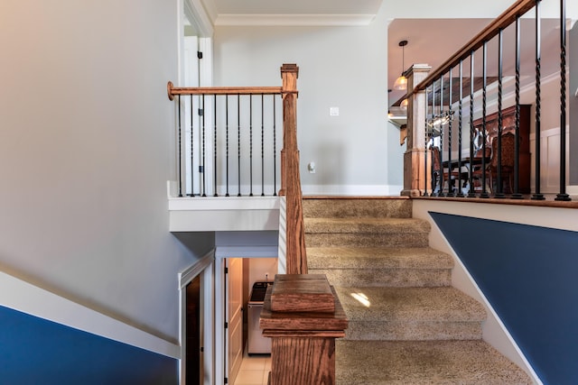 stairway featuring crown molding