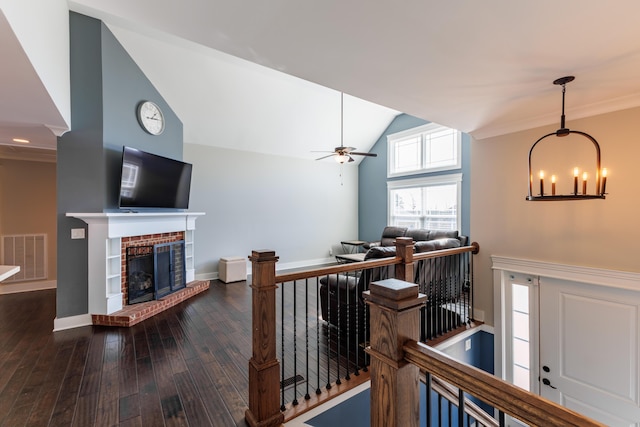 hall featuring dark hardwood / wood-style flooring, a chandelier, and vaulted ceiling