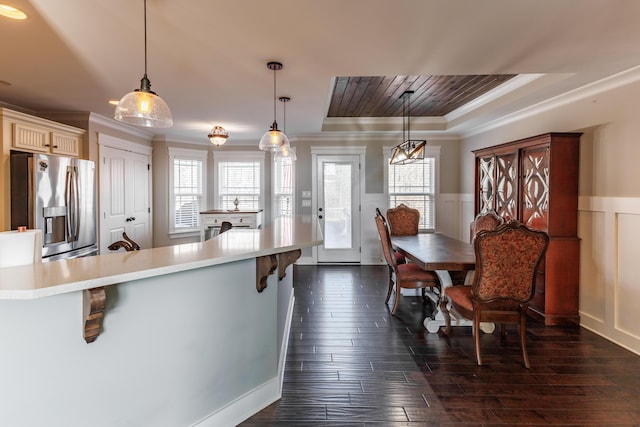 kitchen with pendant lighting, plenty of natural light, and stainless steel fridge