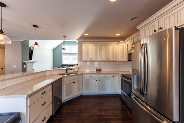 kitchen featuring tasteful backsplash, hanging light fixtures, kitchen peninsula, stainless steel appliances, and dark wood-type flooring