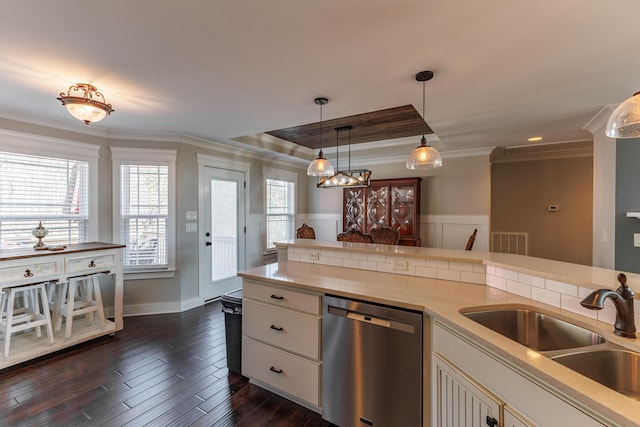 kitchen featuring sink, ornamental molding, dark hardwood / wood-style flooring, dishwasher, and pendant lighting