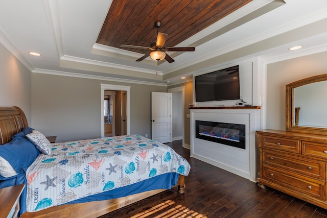 bedroom featuring dark wood-type flooring, wooden ceiling, ornamental molding, a tray ceiling, and ceiling fan