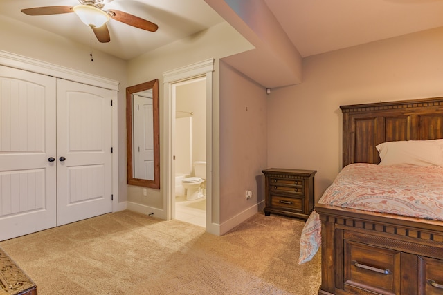 carpeted bedroom featuring a closet, ceiling fan, and ensuite bathroom