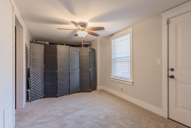 interior space with ceiling fan