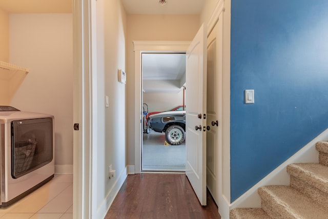 washroom with wood-type flooring and washer and dryer