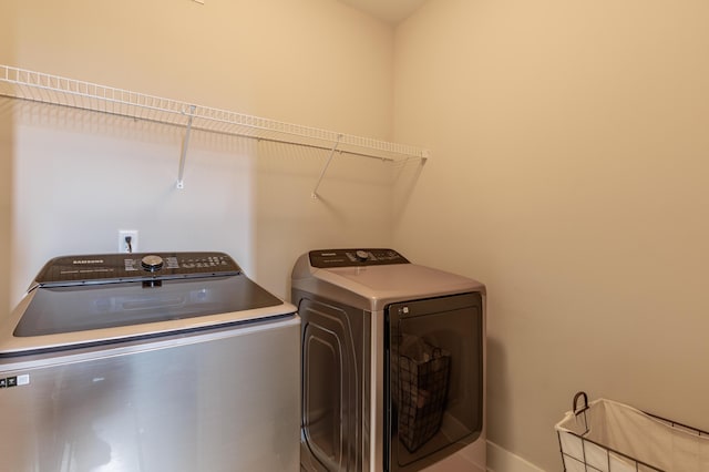 washroom with independent washer and dryer