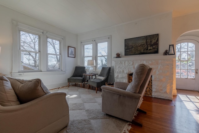 living room with hardwood / wood-style flooring and ornamental molding