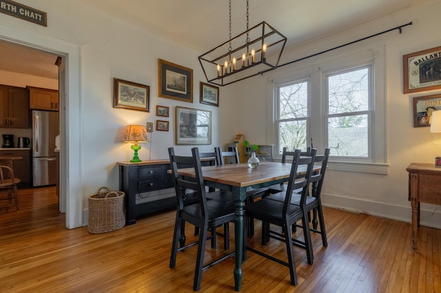 dining area featuring ornamental molding and light wood-type flooring