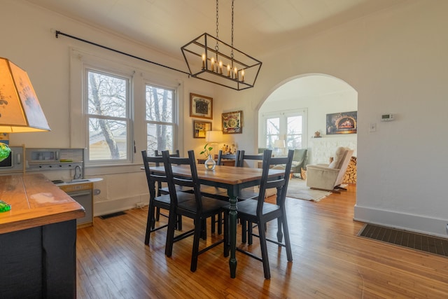 dining room with light hardwood / wood-style floors and french doors