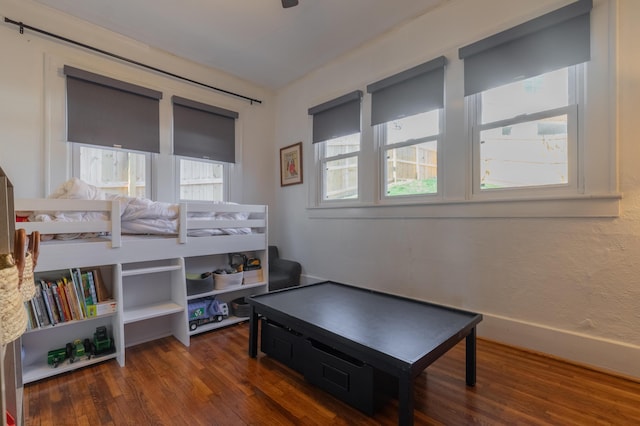 bedroom with dark hardwood / wood-style flooring