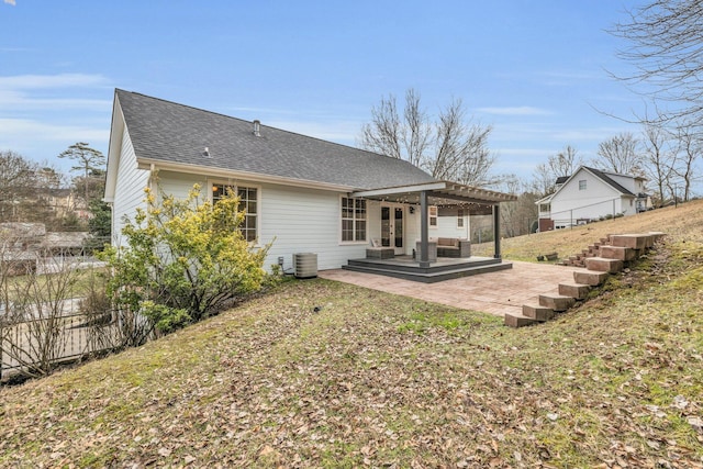 back of house with central air condition unit, a patio, a pergola, and a lawn