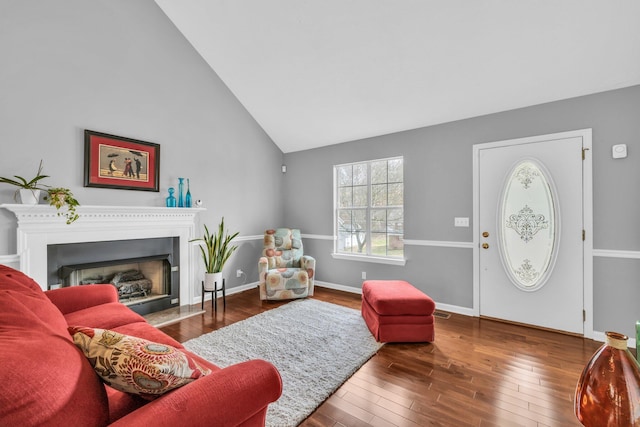 living room with high vaulted ceiling and wood-type flooring