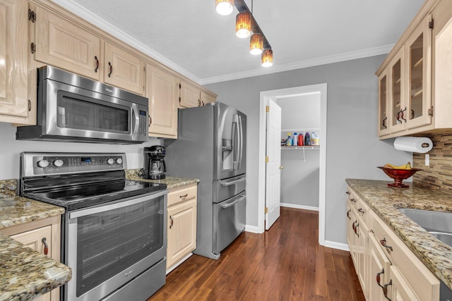 kitchen with stainless steel appliances, dark hardwood / wood-style flooring, light stone countertops, and ornamental molding