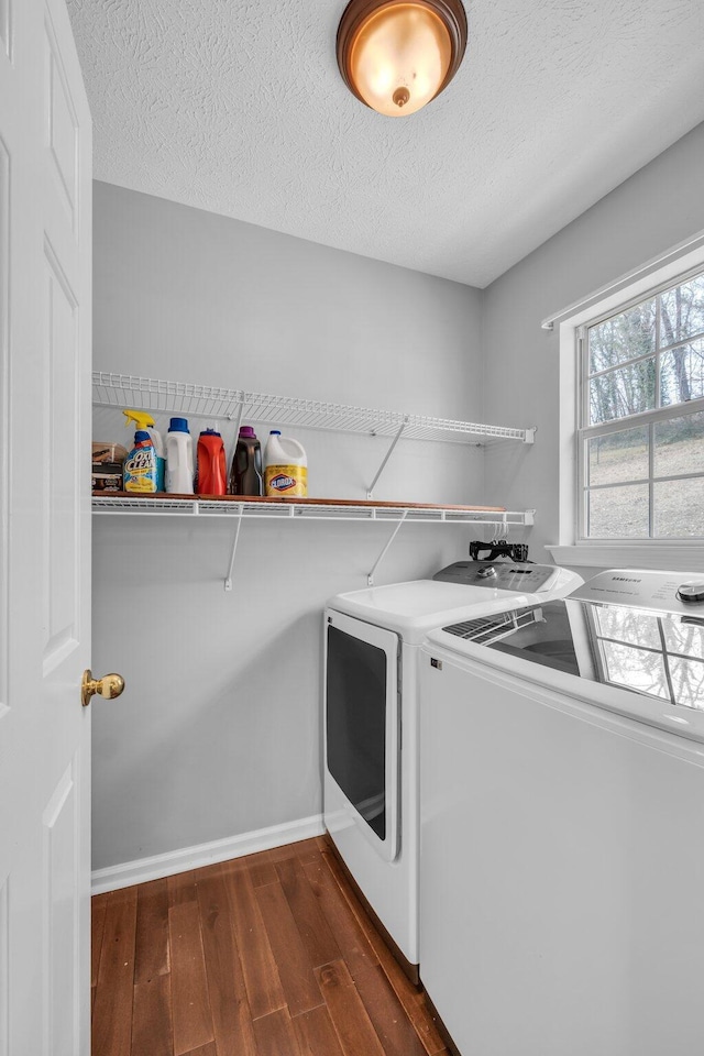 laundry area featuring dark wood-type flooring, separate washer and dryer, and a textured ceiling