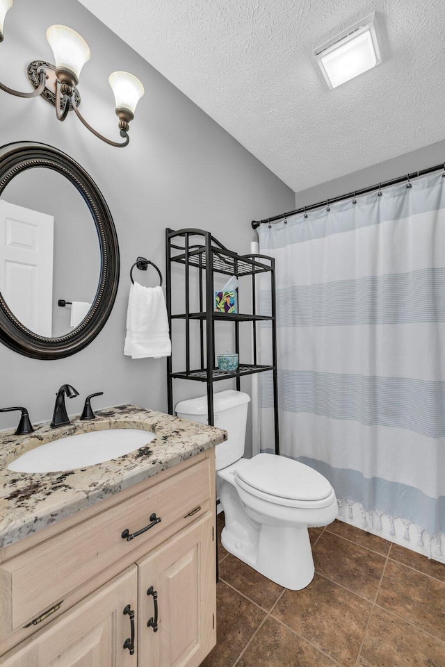 bathroom featuring vanity, toilet, and a textured ceiling