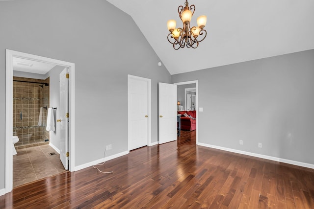 unfurnished bedroom with dark hardwood / wood-style flooring, high vaulted ceiling, and a notable chandelier