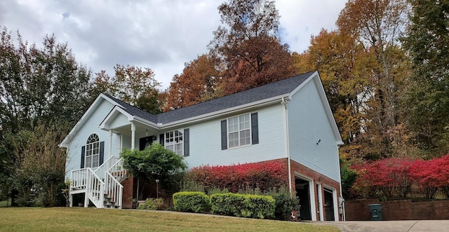 view of front of house with a front lawn and a garage