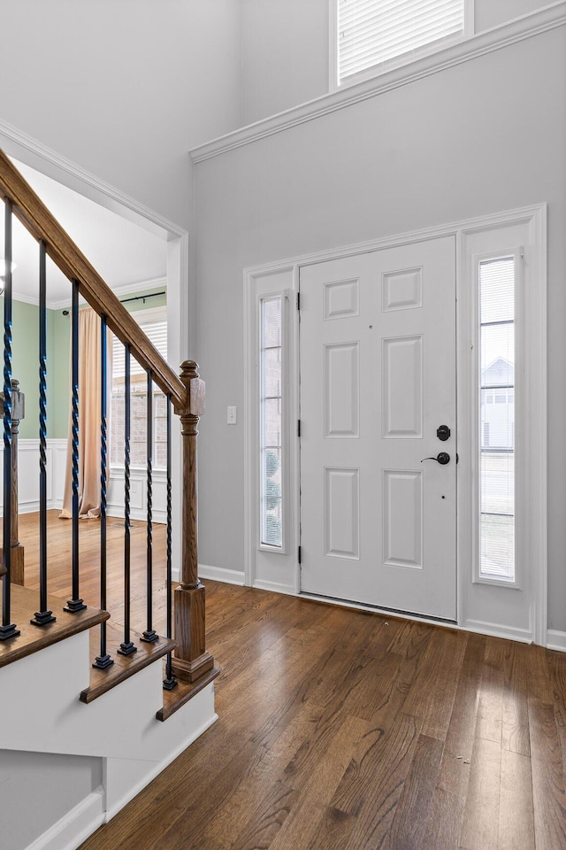 entryway featuring dark wood-type flooring and a high ceiling