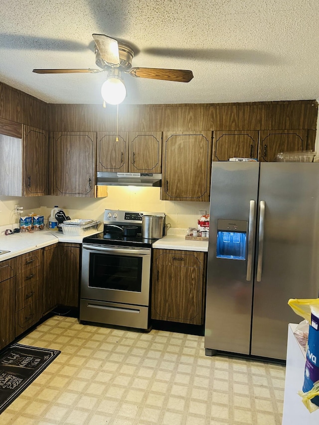 kitchen with dark brown cabinets, ceiling fan, appliances with stainless steel finishes, and a textured ceiling