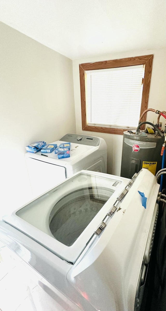 laundry room featuring separate washer and dryer and electric water heater