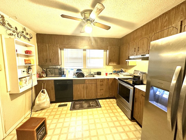 kitchen with ceiling fan, sink, a textured ceiling, and appliances with stainless steel finishes