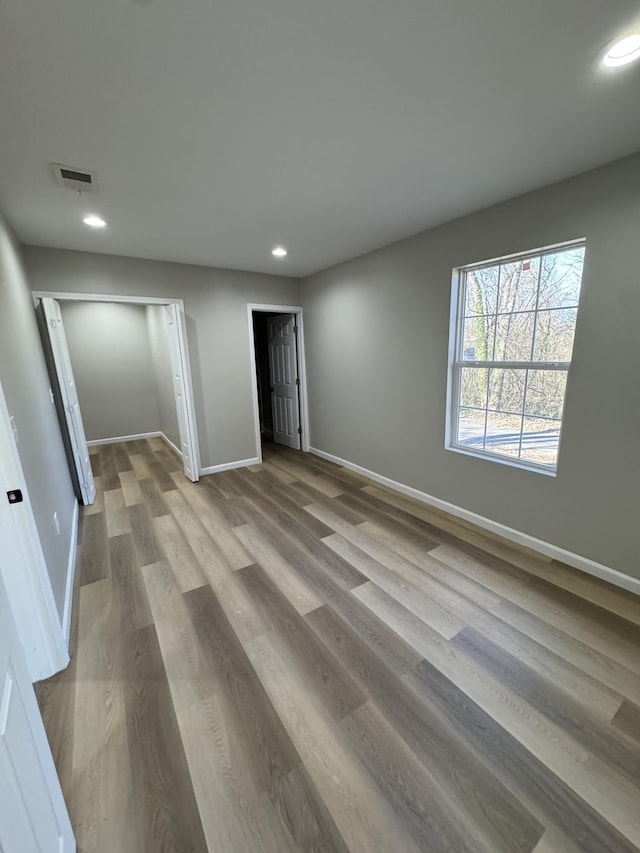 unfurnished bedroom featuring light wood-type flooring