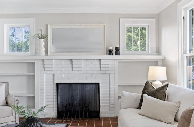 living room featuring built in shelves, a fireplace, and ornamental molding