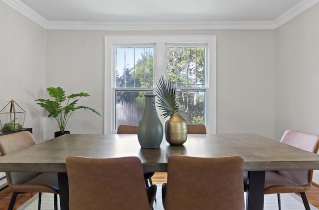 dining space with crown molding and hardwood / wood-style floors