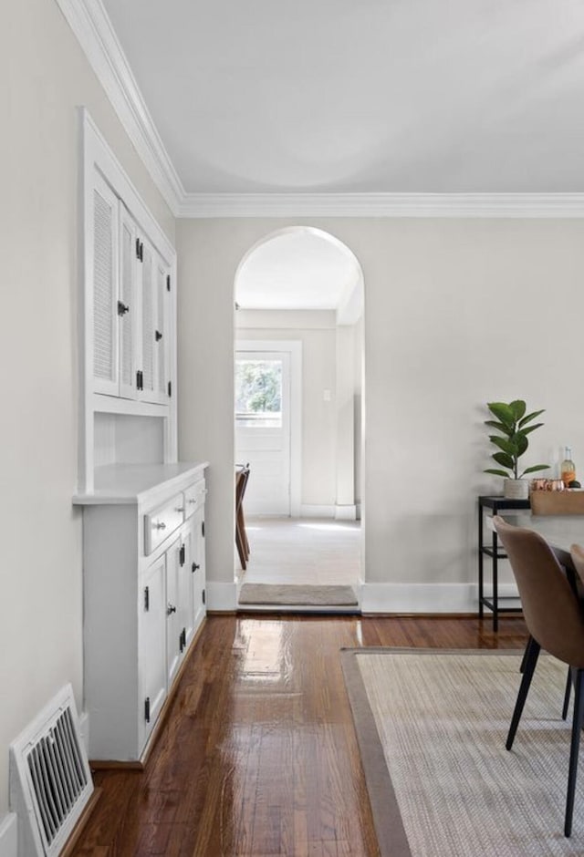 interior space with crown molding and dark hardwood / wood-style floors