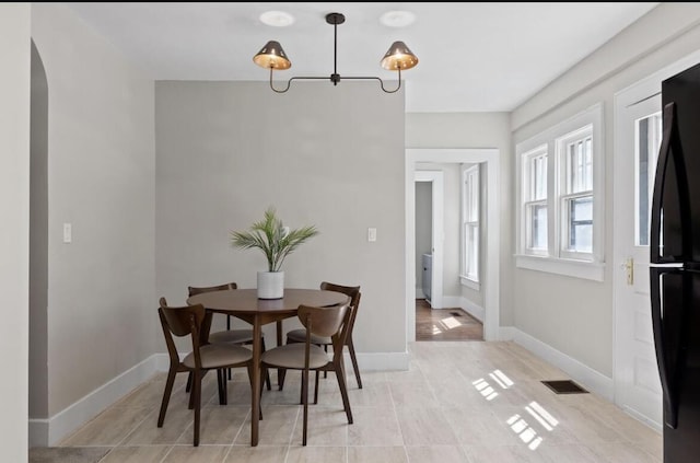 dining area featuring light tile patterned flooring