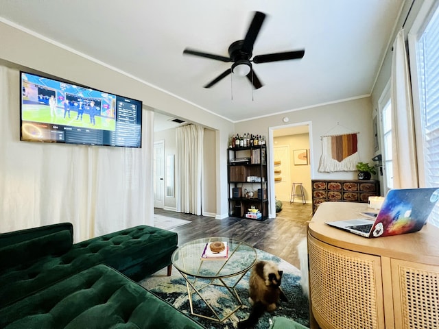 living room with hardwood / wood-style flooring, crown molding, and ceiling fan