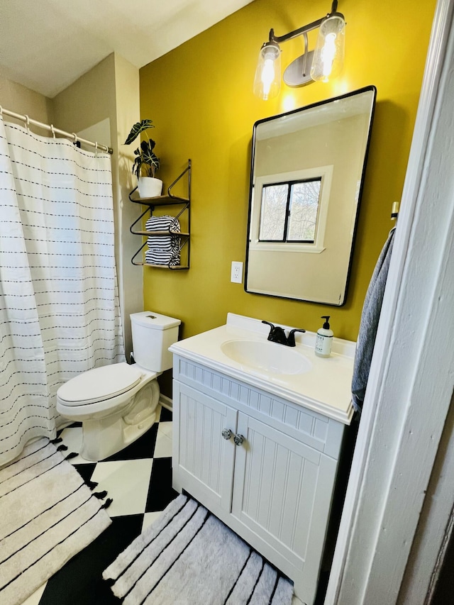 bathroom featuring vanity and toilet