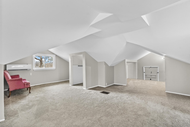 bonus room featuring a wall mounted air conditioner, carpet flooring, and vaulted ceiling