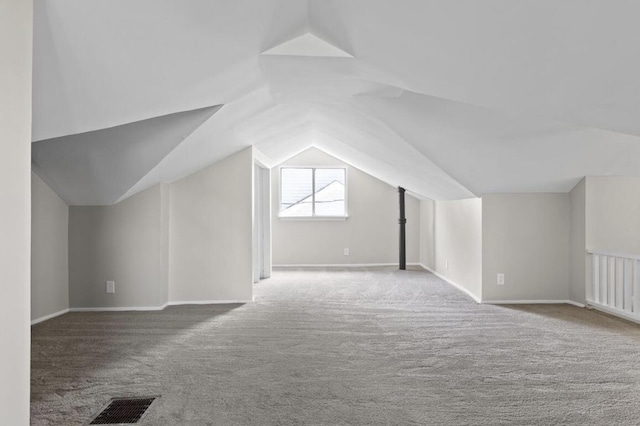 bonus room featuring lofted ceiling and carpet floors