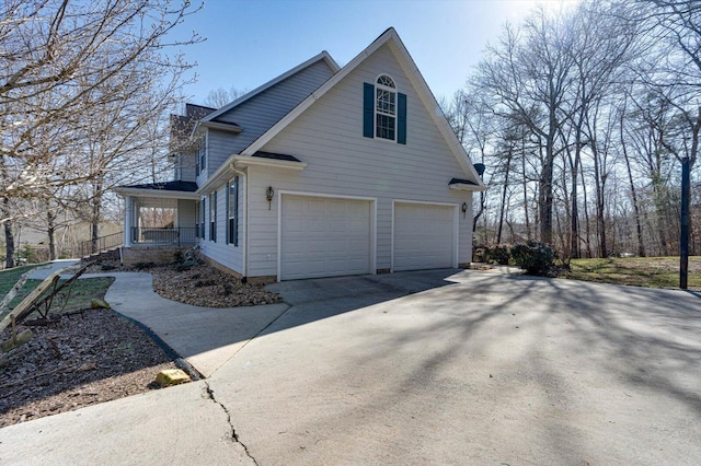 view of side of home with a garage and a porch