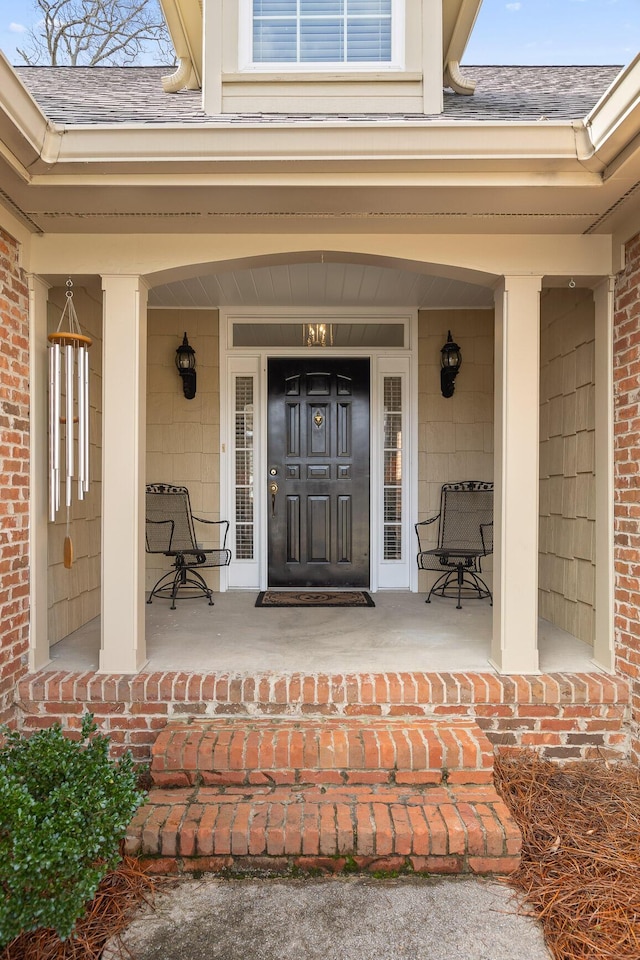 view of exterior entry featuring a porch