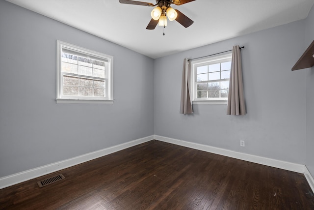 spare room with ceiling fan and dark hardwood / wood-style floors