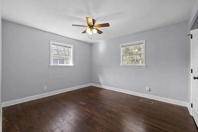 unfurnished room featuring ceiling fan, a healthy amount of sunlight, and dark hardwood / wood-style flooring