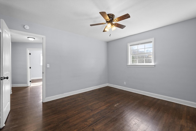 spare room with dark hardwood / wood-style floors and ceiling fan