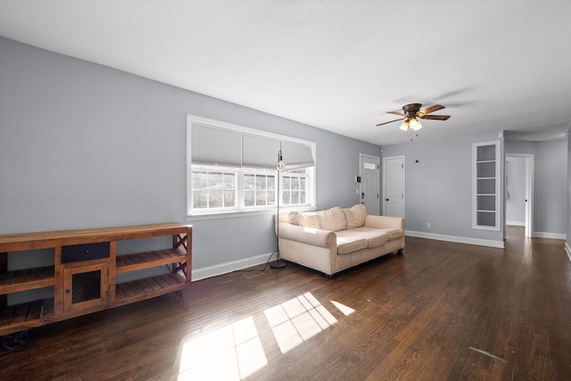 living room with dark wood-type flooring and ceiling fan