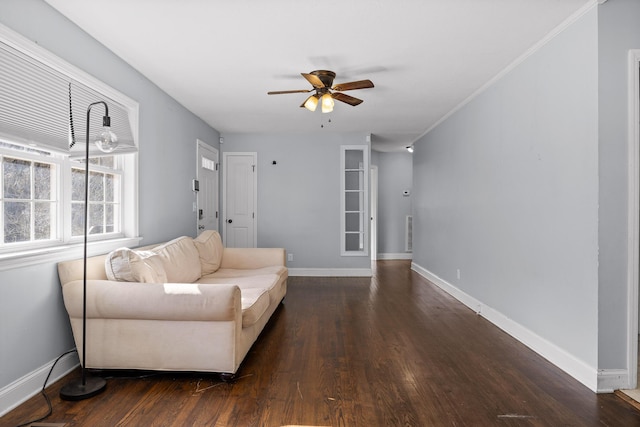 living room featuring crown molding, dark hardwood / wood-style floors, and ceiling fan